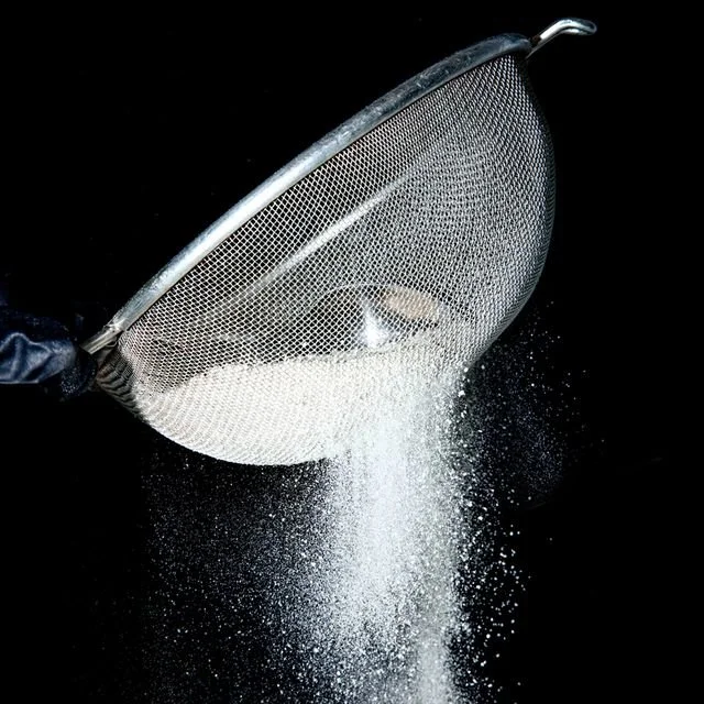 Solventless hash being sifted through a mesh screen